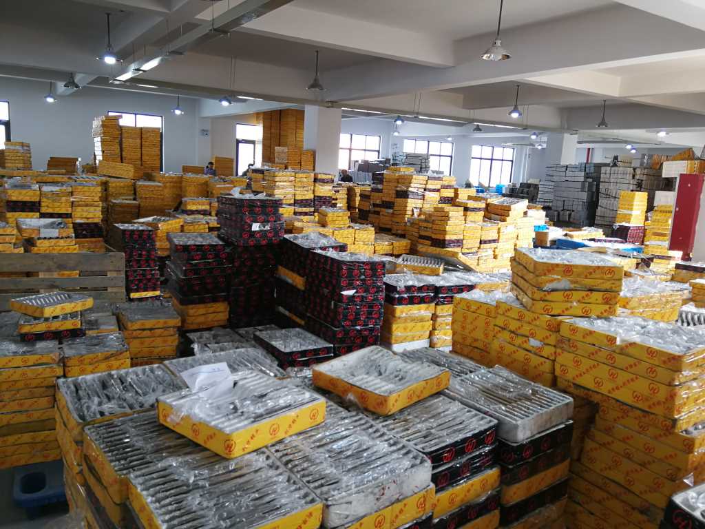 Trays of semi-finished metal hardware stored in a workshop warehouse