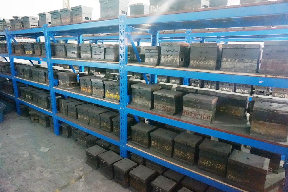 Metal tooling stored on blue workshop shelves